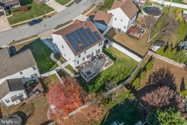 an aerial view of a house with a yard