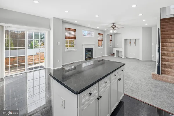 a kitchen with stainless steel appliances granite countertop a sink stove refrigerator and cabinets