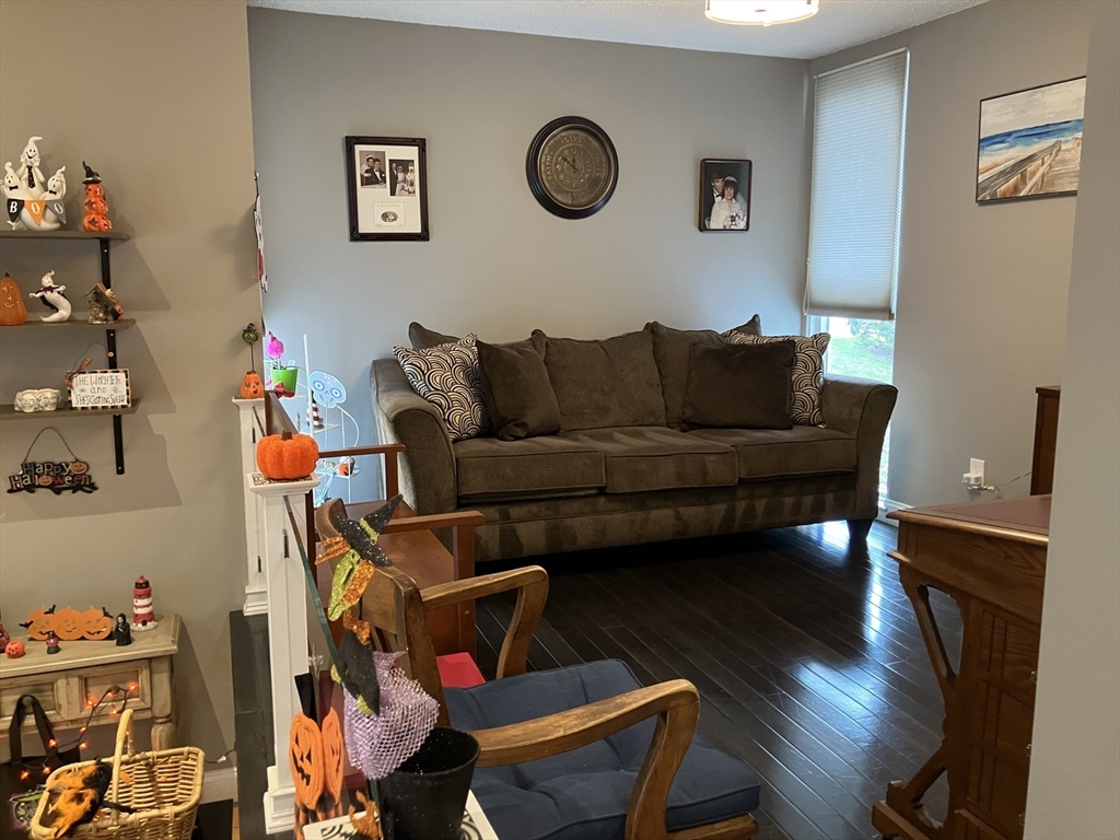255 North Road, Unit 65 Chelmsford, MA 01824 - Photo 15 of 31 a living room with furniture a couch and wooden floor