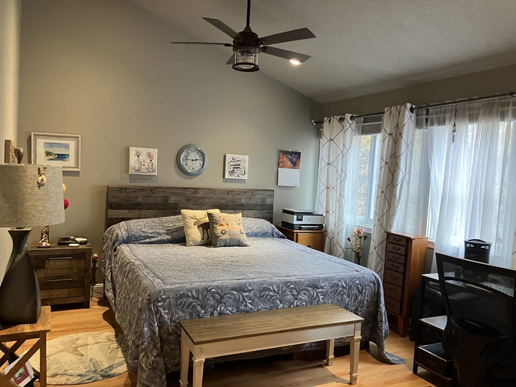 255 North Road, Unit 65 Chelmsford, MA 01824 - Photo 18 of 31 a bedroom with a bed and a chandelier