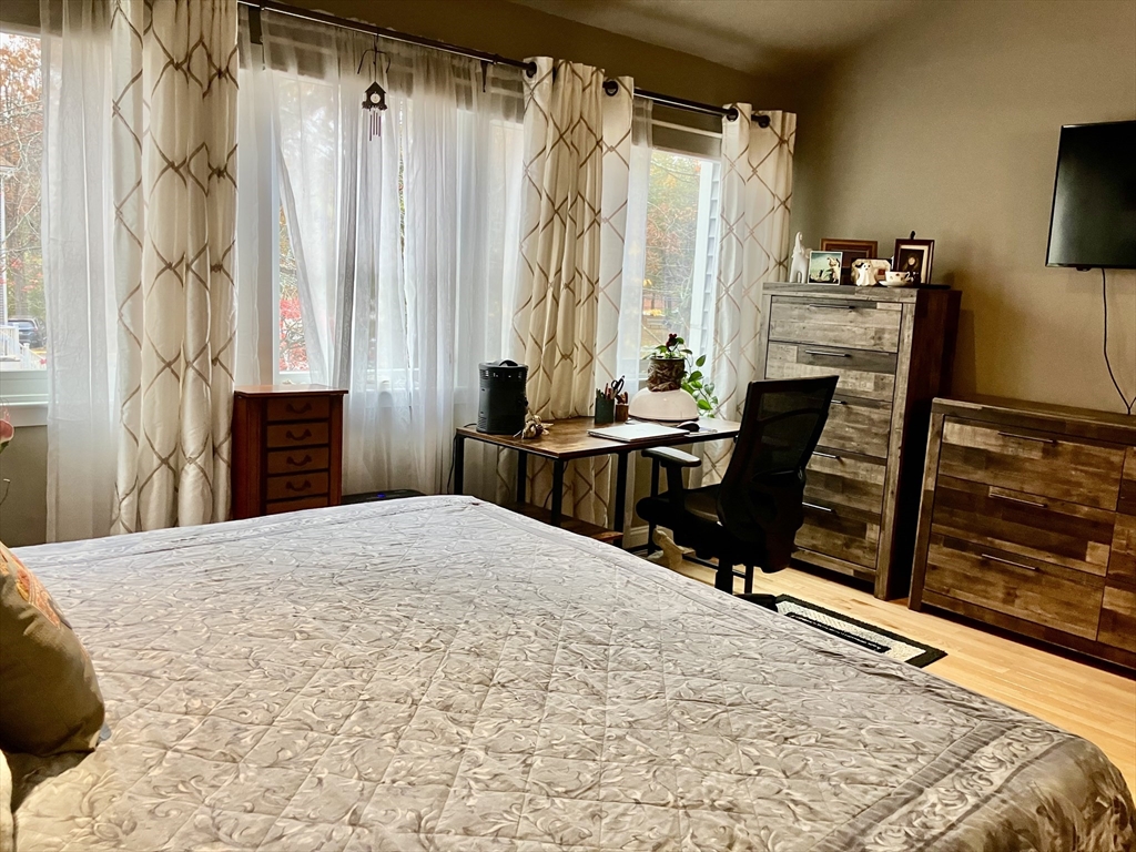 255 North Road, Unit 65 Chelmsford, MA 01824 - Photo 19 of 31 a bedroom with a bed and furniture