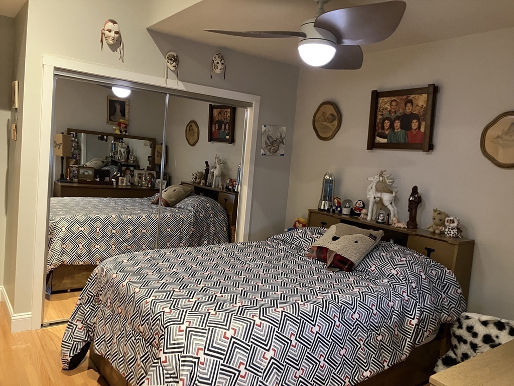 255 North Road, Unit 65 Chelmsford, MA 01824 - Photo 23 of 31 a bedroom with a bed and a mirror on the dresser