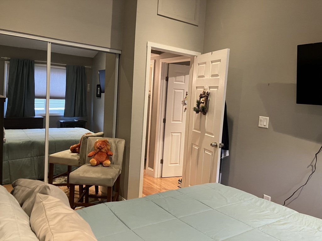 255 North Road, Unit 65 Chelmsford, MA 01824 - Photo 25 of 31 a bedroom with a bed and a television