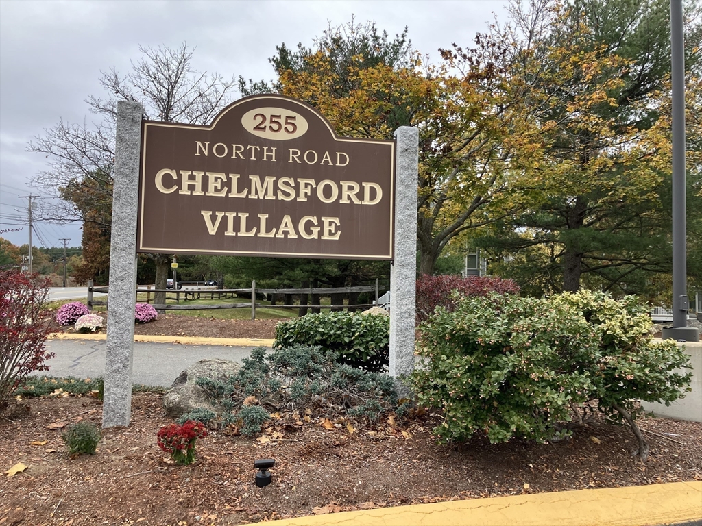 255 North Road, Unit 65 Chelmsford, MA 01824 - Photo 31 of 31 a sign that is sitting on a brick wall