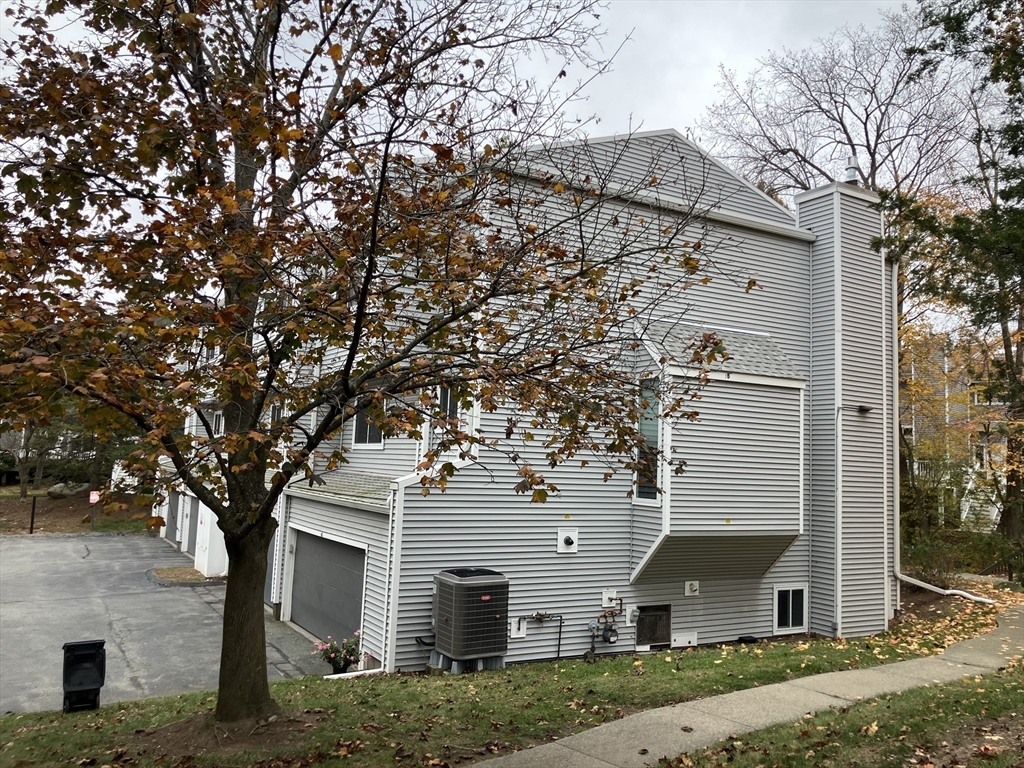 255 North Road, Unit 65 Chelmsford, MA 01824 - Photo 4 of 31 front view of a house with a trees