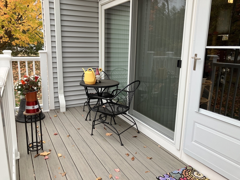 255 North Road, Unit 65 Chelmsford, MA 01824 - Photo 6 of 31 a view of a balcony with furniture and wooden floor