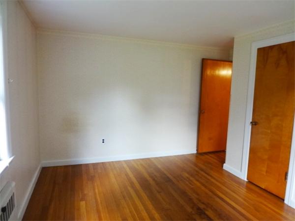 3 Girdler Road Marblehead, MA 01945 - Photo 4 of 8 an empty room with wooden floor and windows