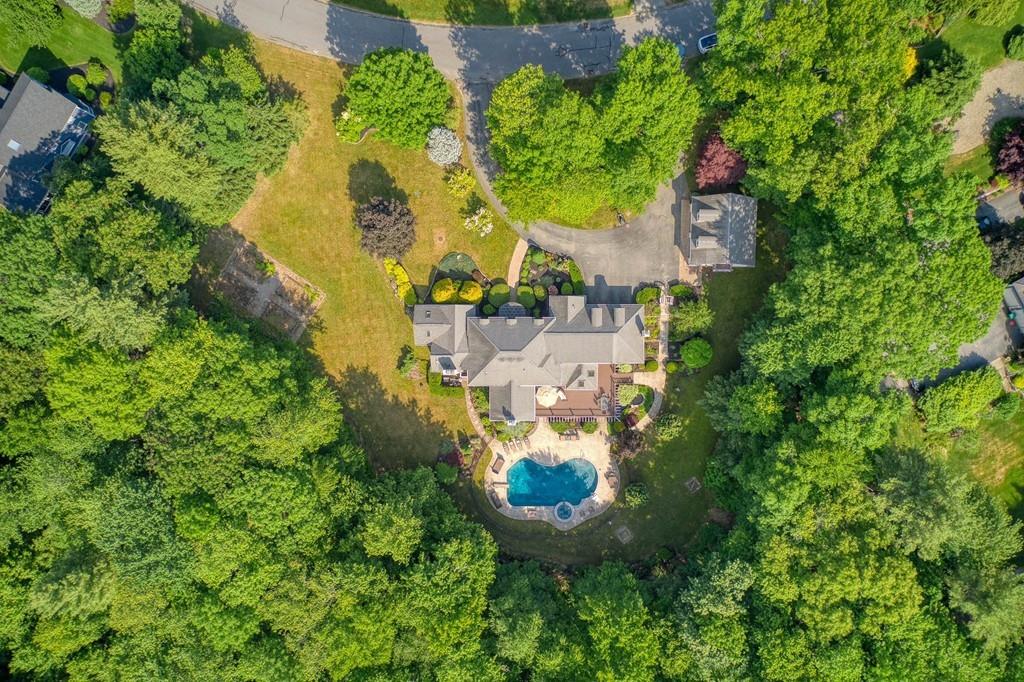 an aerial view of a house with a yard and swimming pool