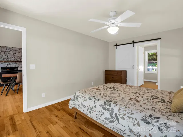 a bedroom with a bed and a painting on the wall