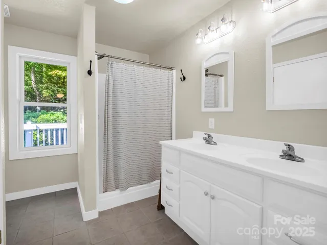 a bathroom with a sink a mirror and a shower