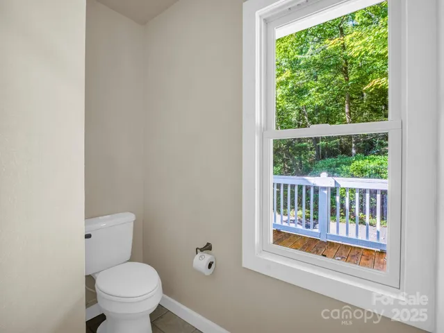 a bathroom with a toilet and a window