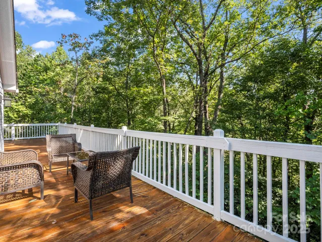 a balcony with wooden floor and outdoor space