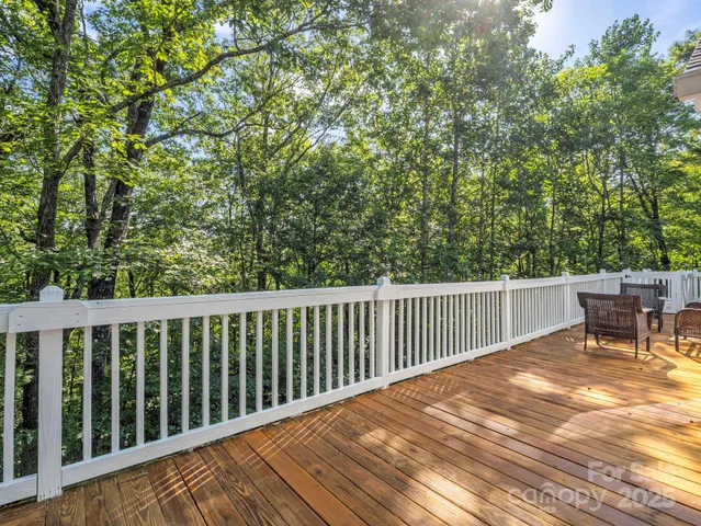 a balcony with wooden floor and outdoor space