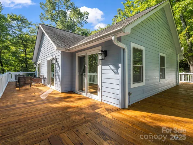 a view of a house with wooden floor and backyard