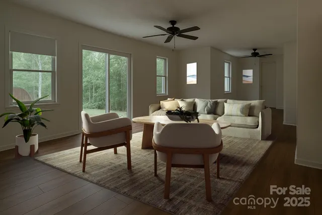 a living room with furniture a window and a flat screen tv