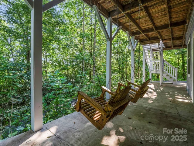 a backyard of a house with table and chairs