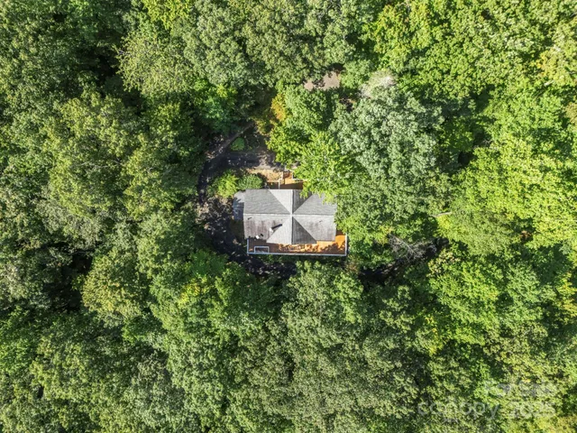 a backyard of a house with a yard and outdoor seating