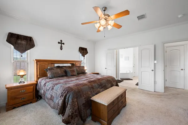 a spacious en suite bathroom with a granite countertop sink mirror and shower