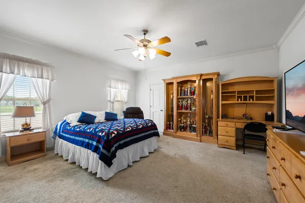 a bedroom with a bed and a chandelier