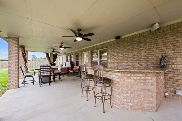 a view of a patio with chairs and a table