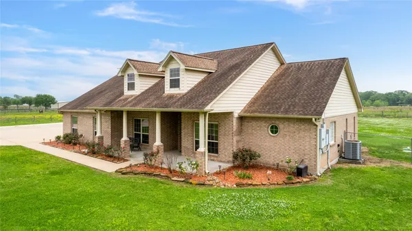 a view of a house with a yard and sitting area