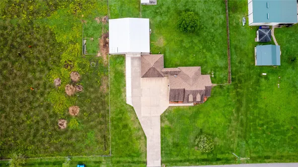 an aerial view of a house with garden space and street view