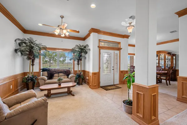 a view of a dining room with furniture and chandelier