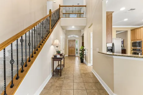 a hallway with a dining table and chairs
