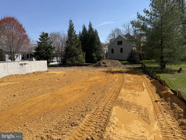 a view of yard with swimming pool and trees