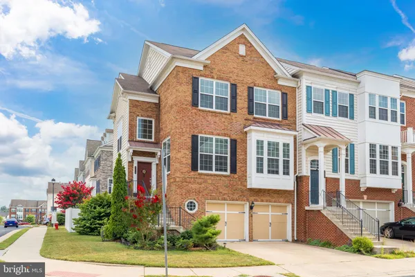 a front view of a multi story residential apartment building with yard