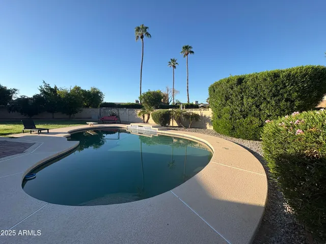a view of a swimming pool with a chairs