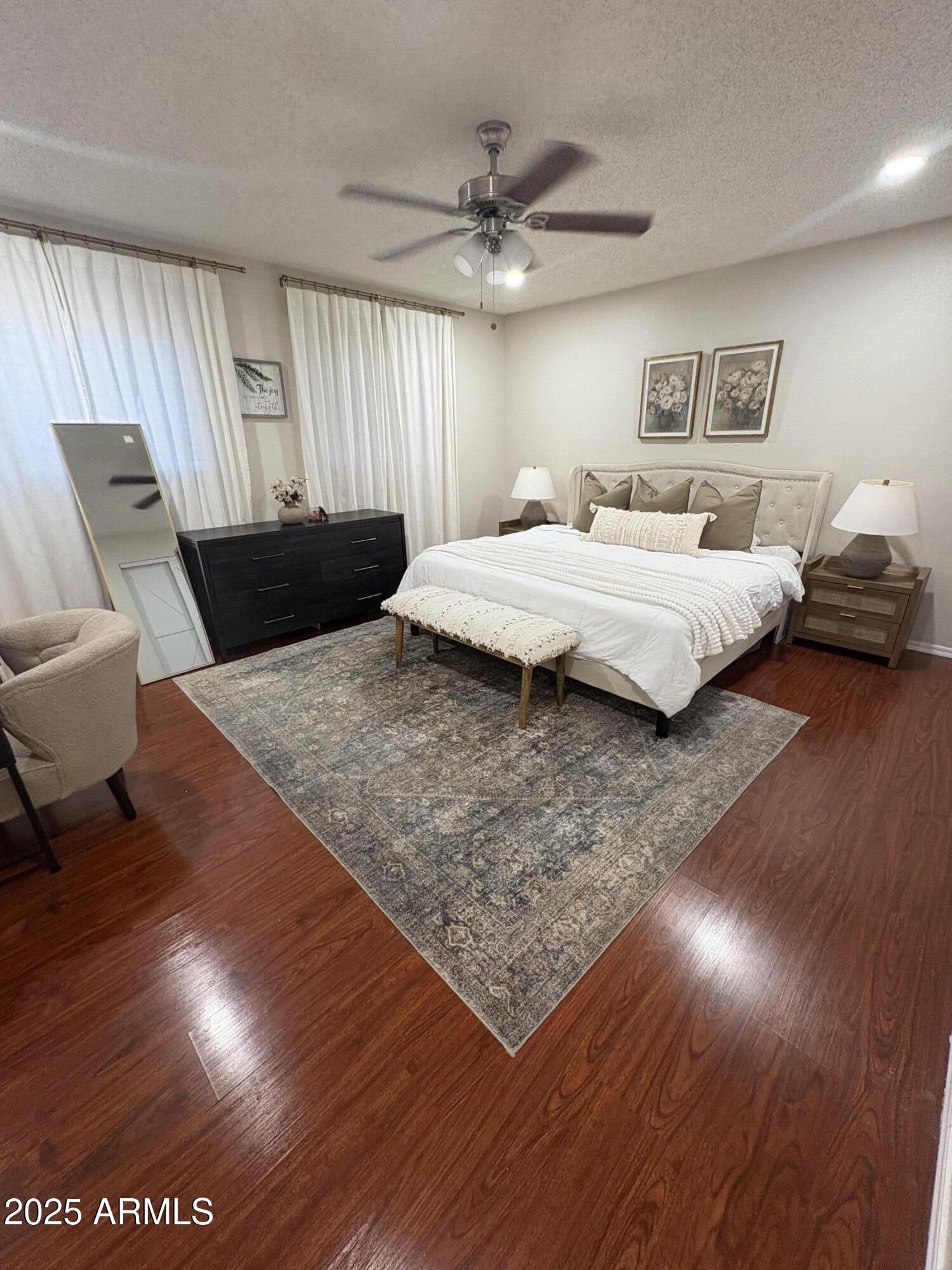5021 West Echo Lane Glendale, AZ 85302 - Photo 4 of 7 a bedroom with a bed and wooden floor