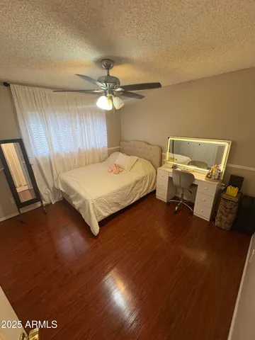 a spacious bedroom with a bed and a chandelier