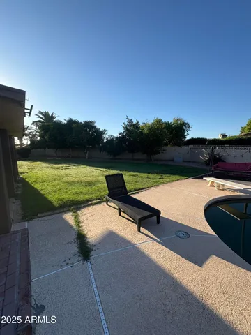 a view of swimming pool with seating area and lake view