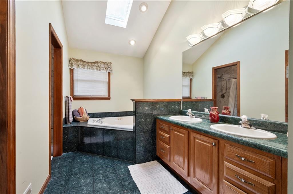 106 Good Luck Lane Mars, PA 16046 - Photo 20 of 33 a spacious bathroom with a double vanity sink and a mirror