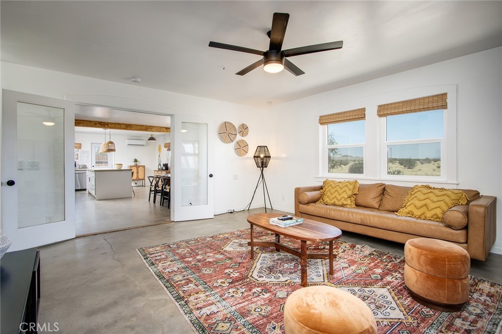 64975 Sun Oro Road Joshua Tree, CA 92252 - Photo 15 of 52 a living room with furniture and a large window