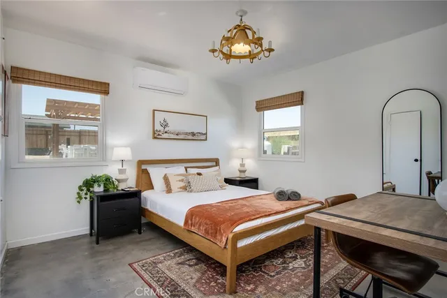 a bedroom with a bed and a painting on the wall