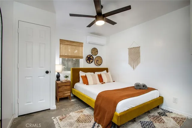 a bedroom with a bed a table and chair