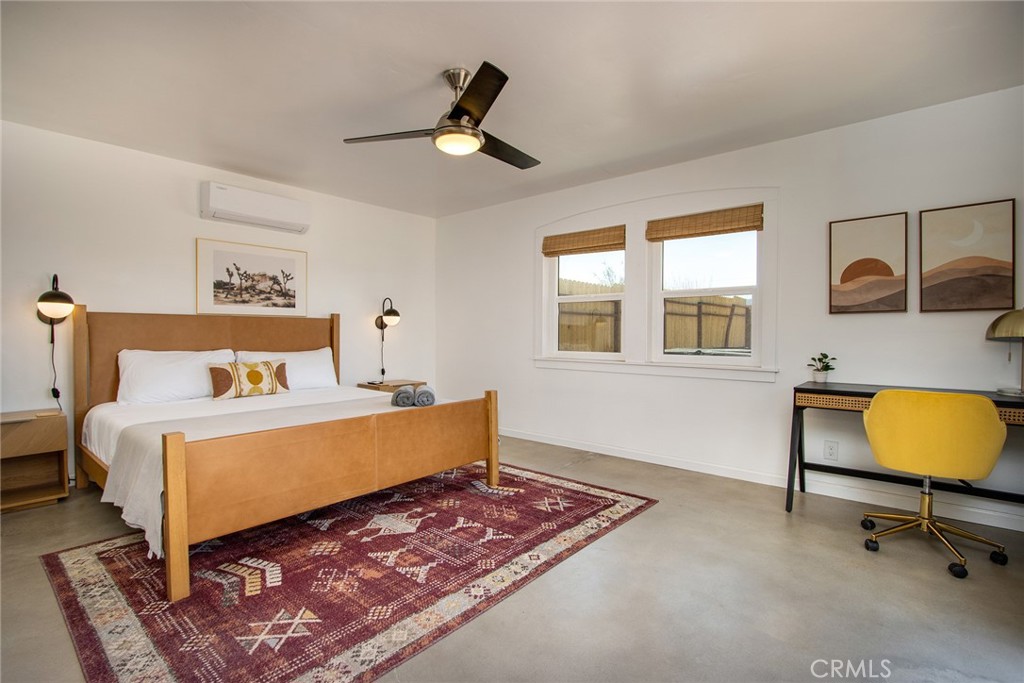 64975 Sun Oro Road Joshua Tree, CA 92252 - Photo 29 of 52 a bedroom with a bed a table and chair