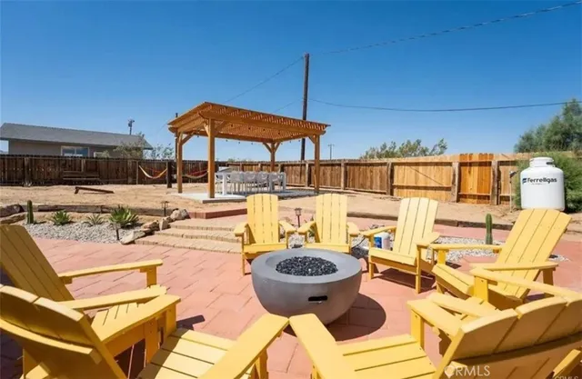 a view of a patio with chairs and umbrellas