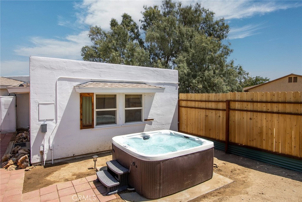 64975 Sun Oro Road Joshua Tree, CA 92252 - Photo 35 of 52 a front view of a house with a yard