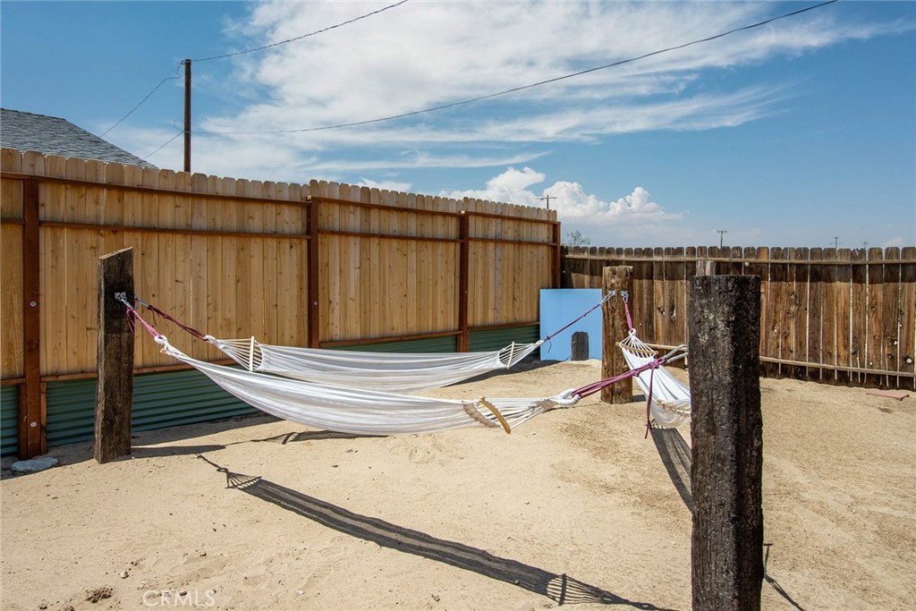 64975 Sun Oro Road Joshua Tree, CA 92252 - Photo 38 of 52 a view of a terrace with wooden walls