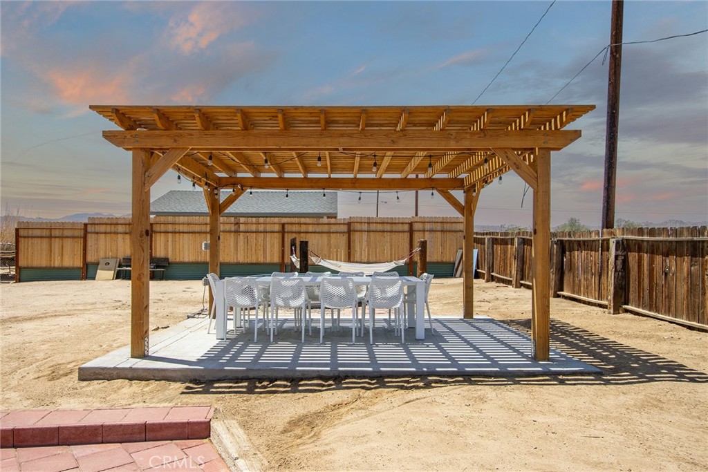 64975 Sun Oro Road Joshua Tree, CA 92252 - Photo 39 of 52 a view of a patio with a table and chairs