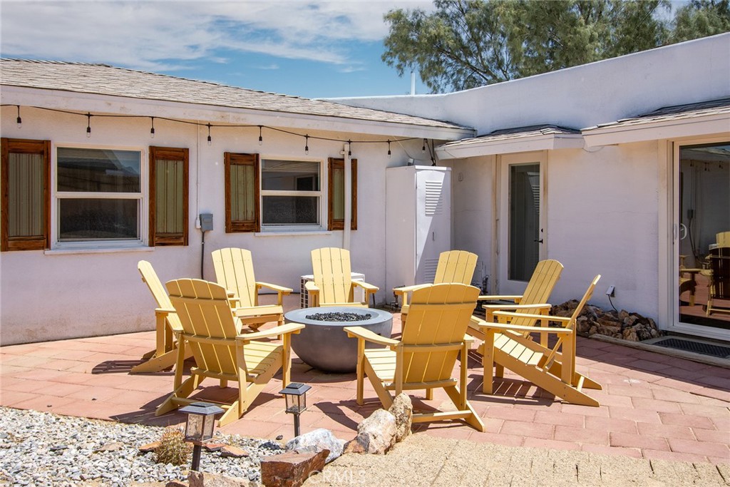 64975 Sun Oro Road Joshua Tree, CA 92252 - Photo 43 of 52 a view of a patio with table and chairs