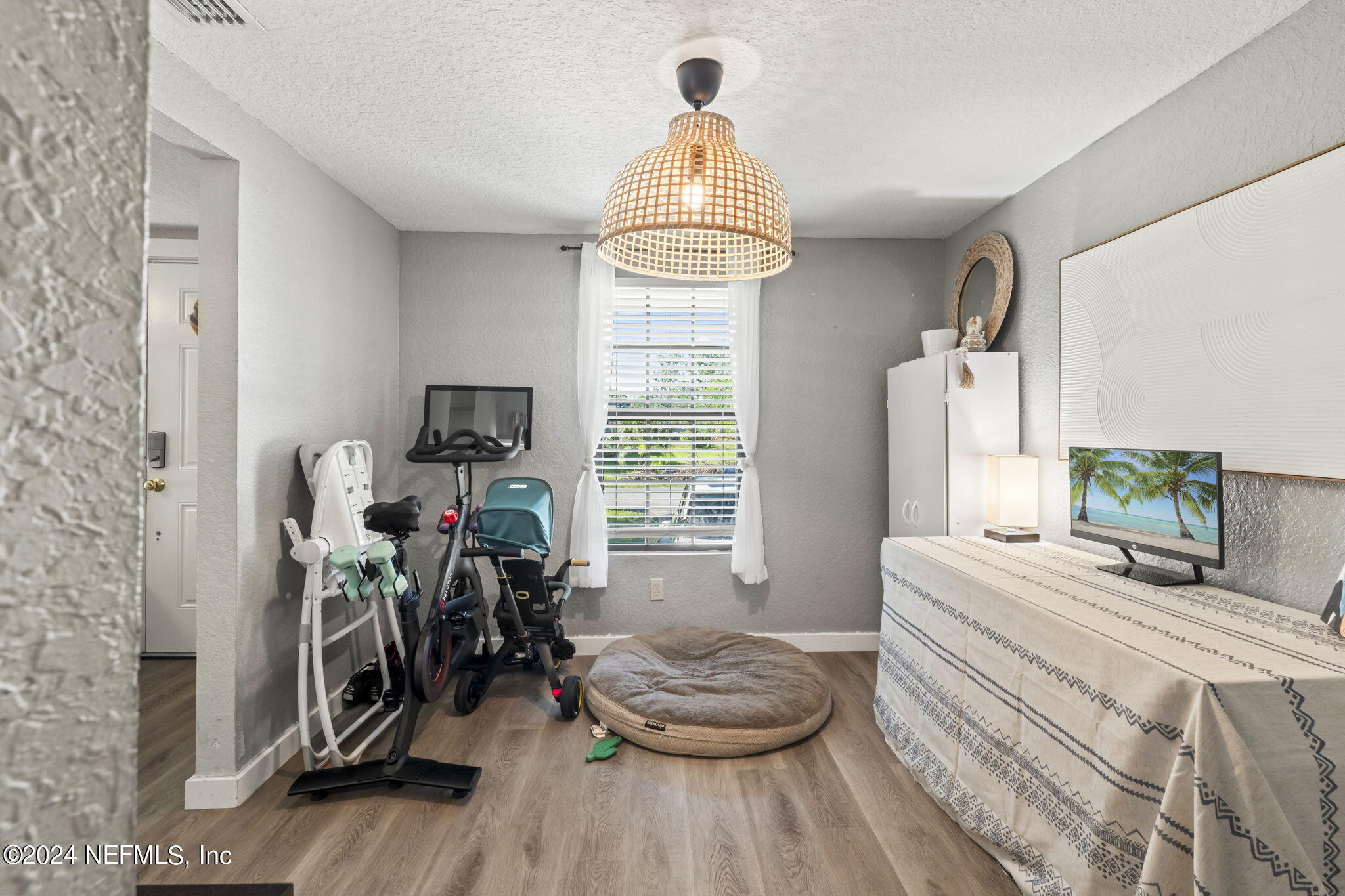 13548 Chauny Road Jacksonville, FL 32246 - Photo 16 of 55 a bedroom with a bed and a wooden floor