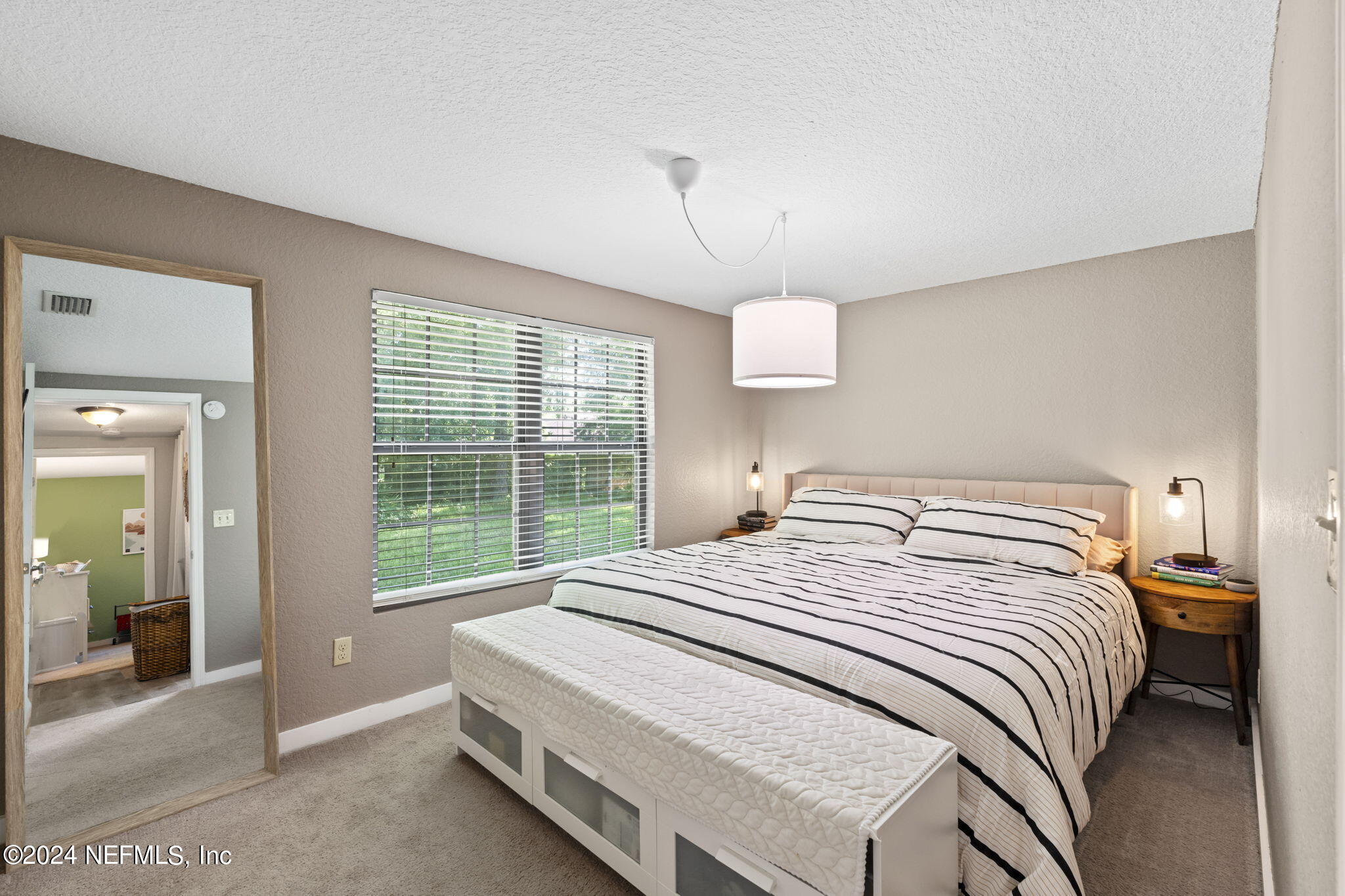 13548 Chauny Road Jacksonville, FL 32246 - Photo 18 of 55 a bedroom with a bed and a large window