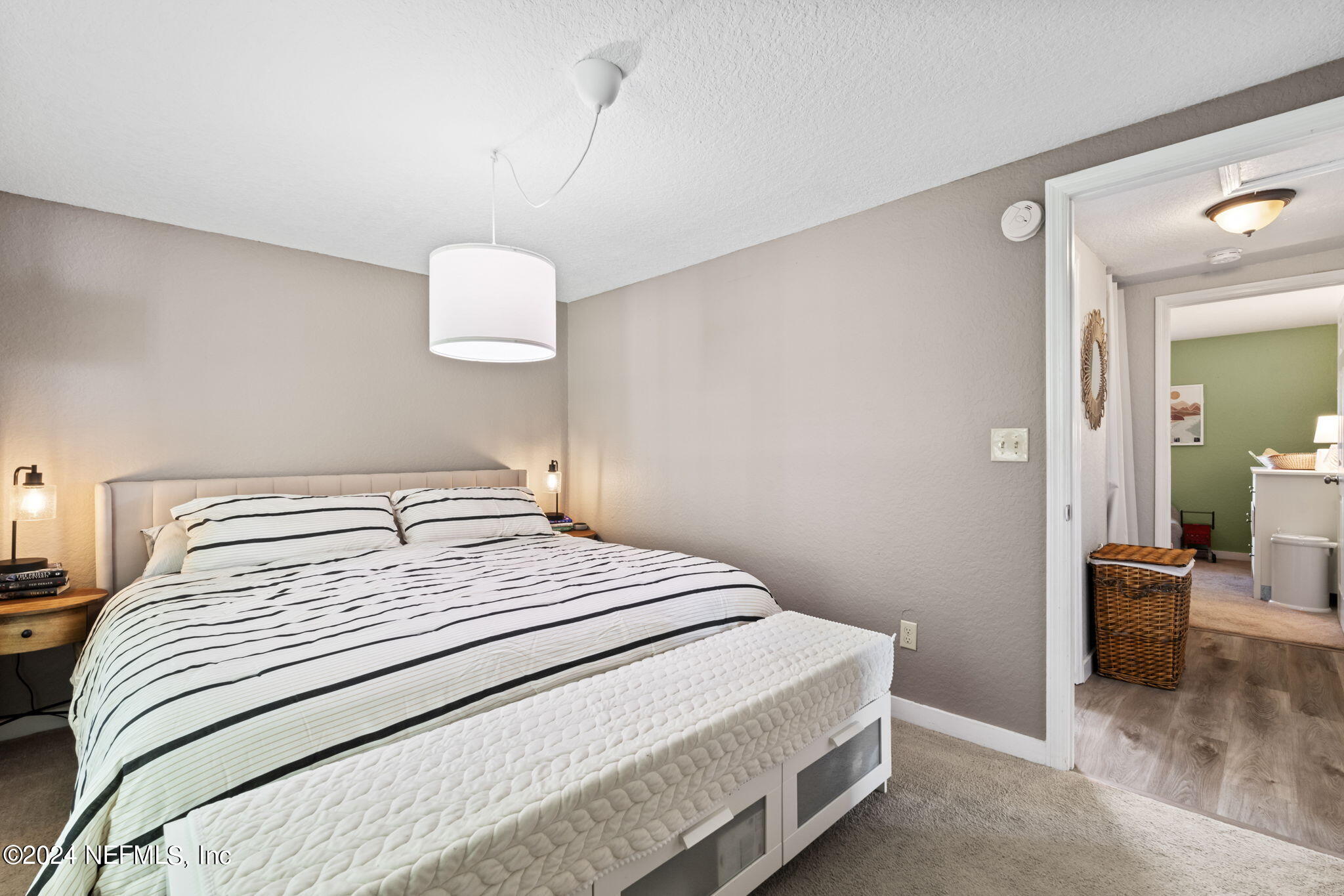 13548 Chauny Road Jacksonville, FL 32246 - Photo 19 of 55 a bedroom with a bed and a lamp