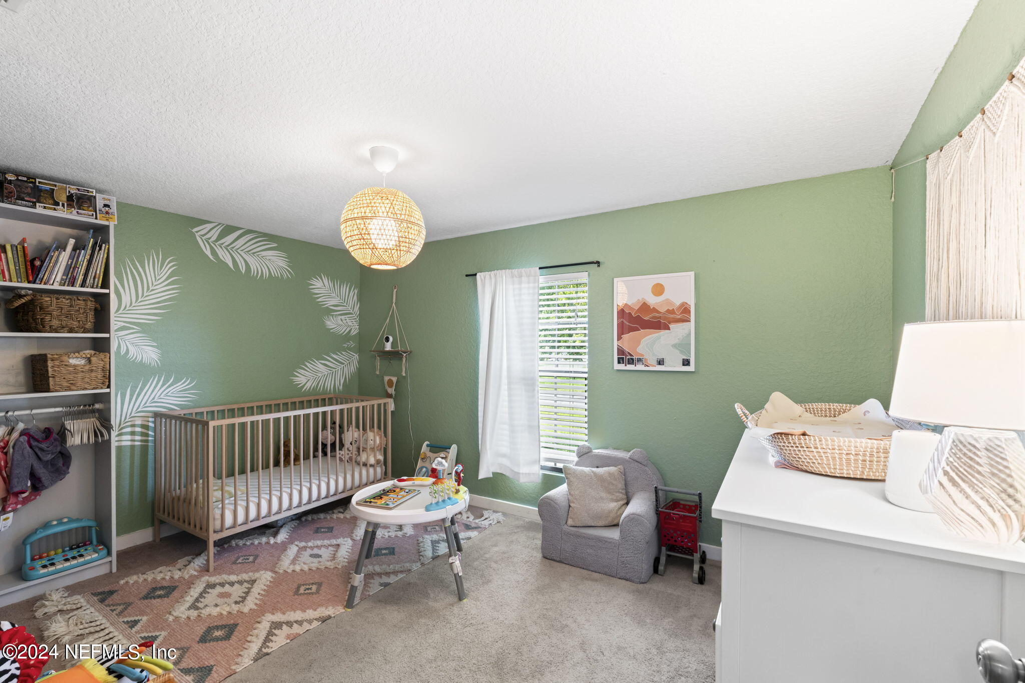 13548 Chauny Road Jacksonville, FL 32246 - Photo 21 of 55 a living room with furniture a baby crib and a window
