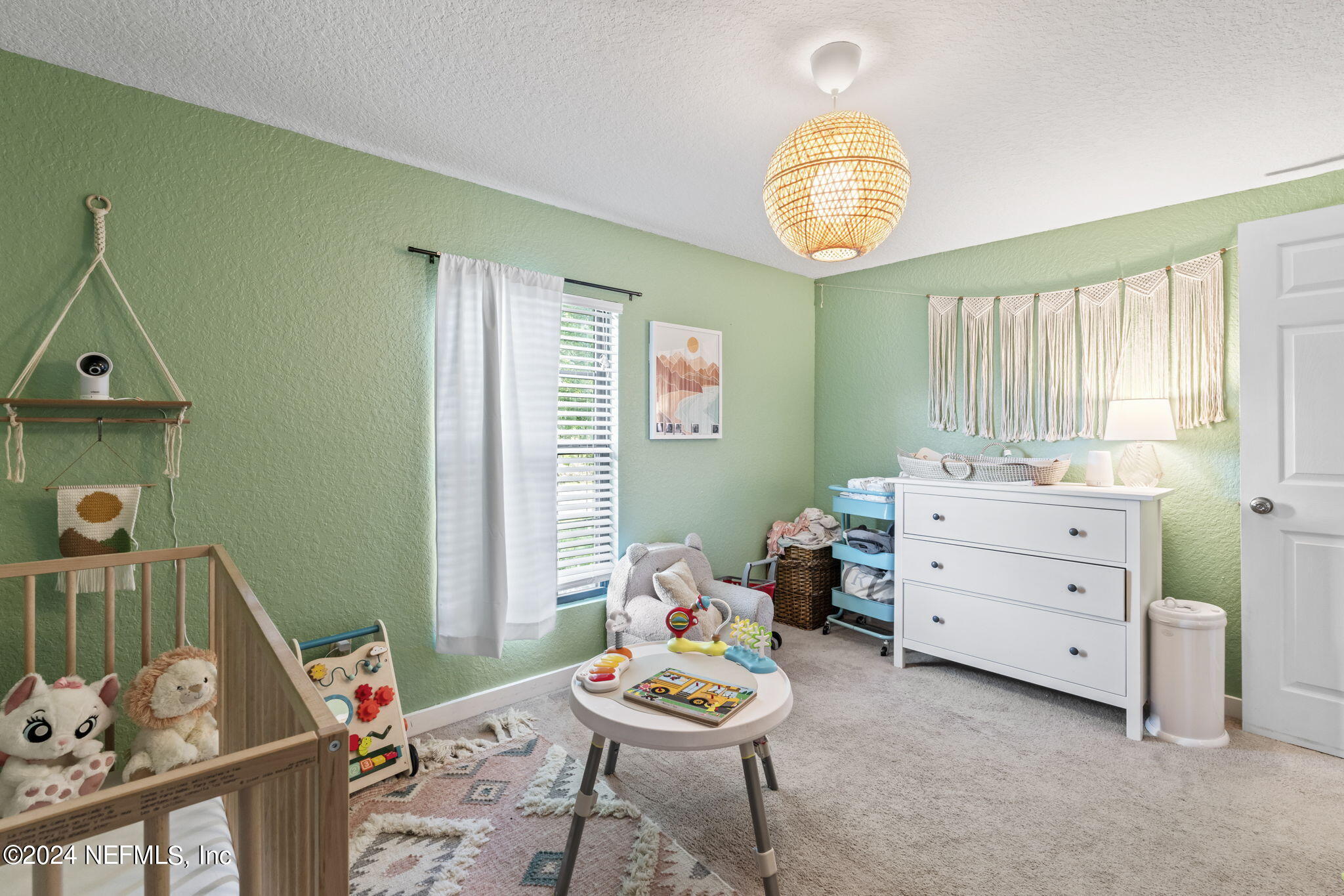 13548 Chauny Road Jacksonville, FL 32246 - Photo 23 of 55 a room with a baby crib a chandelier fan and a window