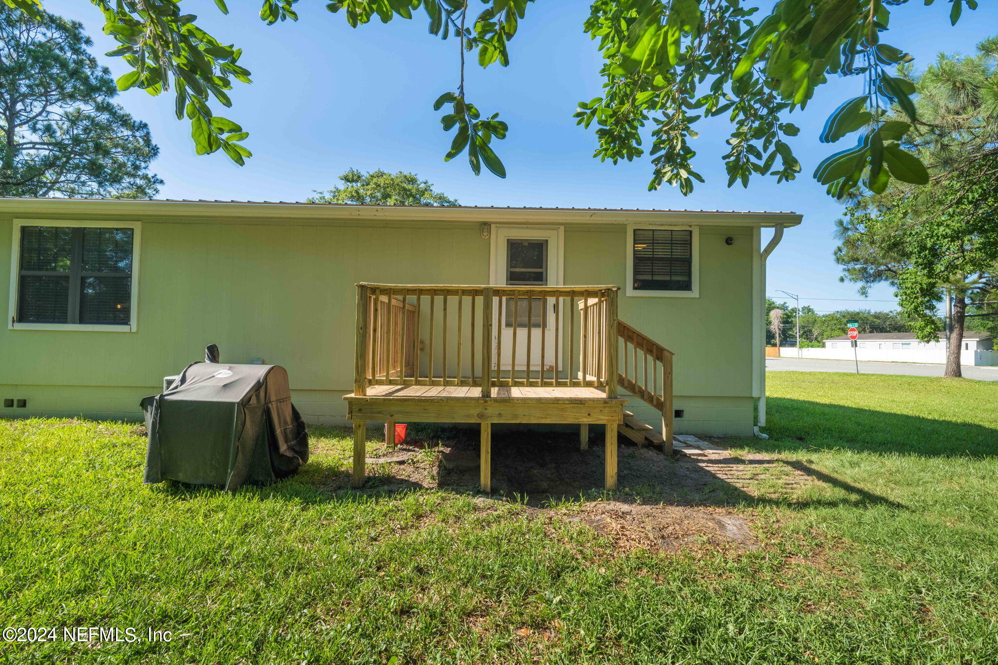 13548 Chauny Road Jacksonville, FL 32246 - Photo 27 of 55 a view of a patio with table and chairs potted plants and large tree
